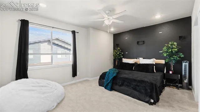 a bedroom with a large bed and a chandelier