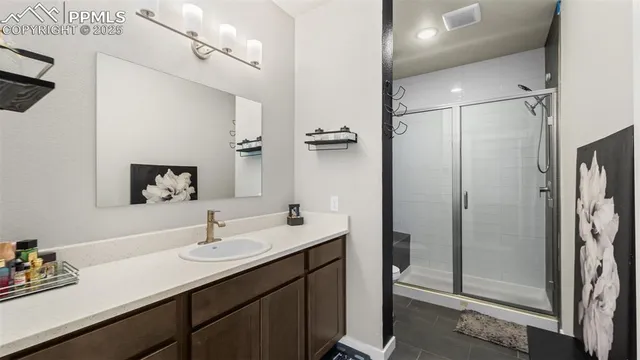 a bathroom with a sink double vanity and a shower