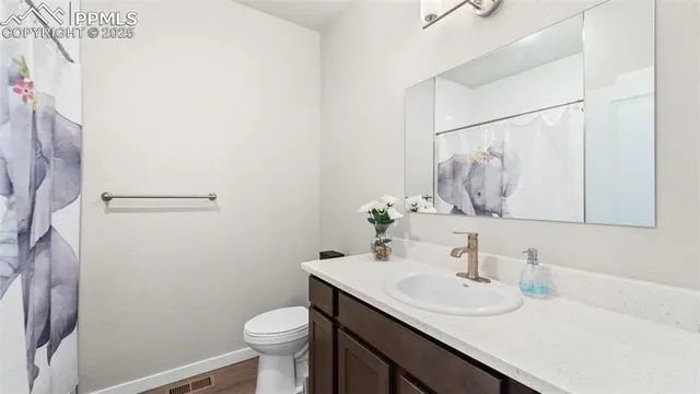 a bathroom with a sink toilet and mirror