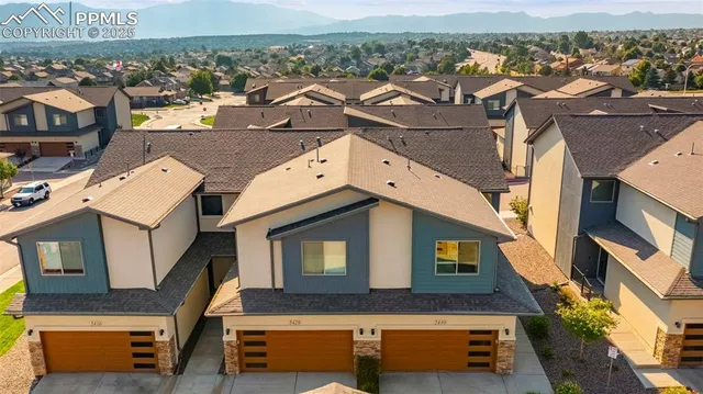 an aerial view of a house with a yard