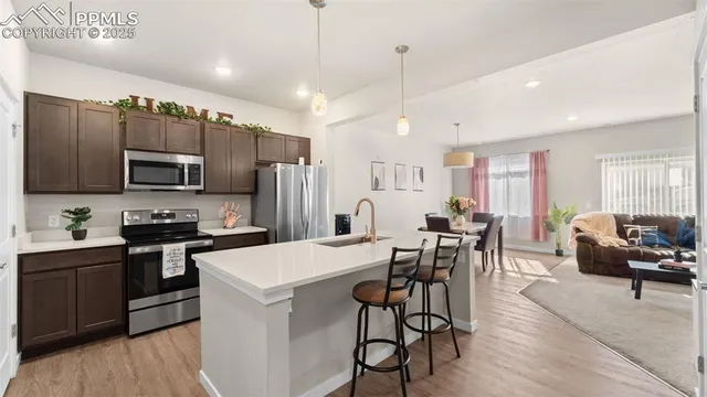 a kitchen with cabinets a sink a counter space stainless steel appliances and cabinets