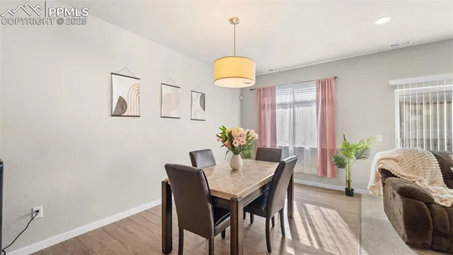 a dining room with furniture and window