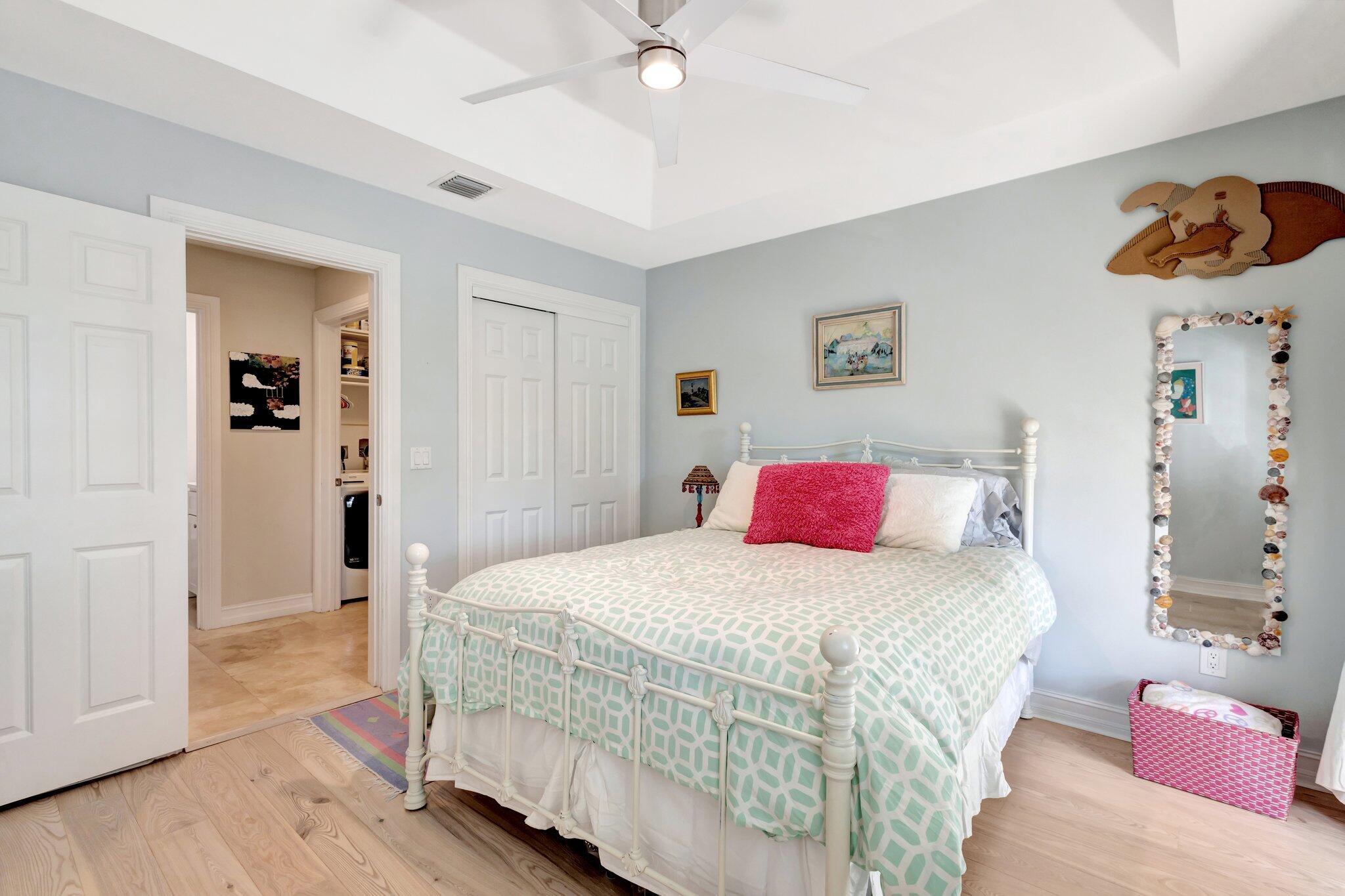 213 Kings Lynn Delray Beach, FL 33444 - Photo 23 of 39 a bedroom with a bed and a chandelier