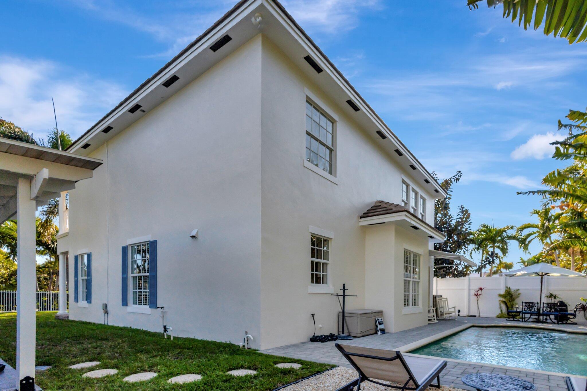 213 Kings Lynn Delray Beach, FL 33444 - Photo 30 of 39 a front view of house with yard