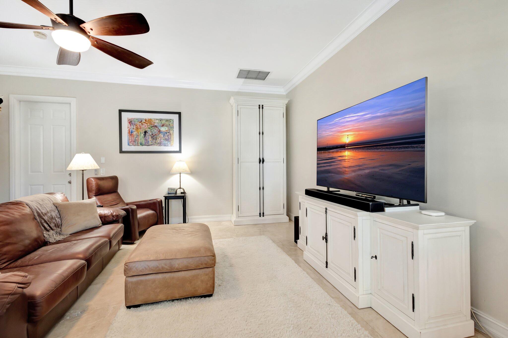 213 Kings Lynn Delray Beach, FL 33444 - Photo 36 of 39 a living room with furniture and a flat screen tv
