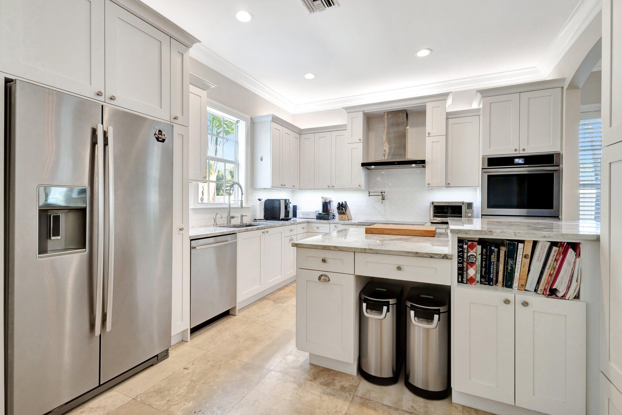213 Kings Lynn Delray Beach, FL 33444 - Photo 37 of 39 a kitchen with a refrigerator and a stove top oven