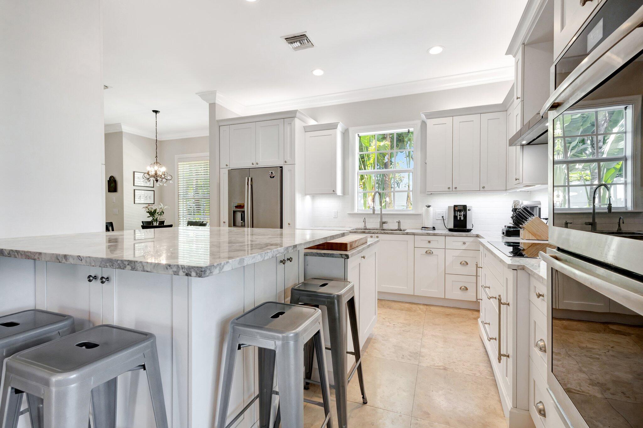 213 Kings Lynn Delray Beach, FL 33444 - Photo 10 of 39 a kitchen with a sink stove and cabinets