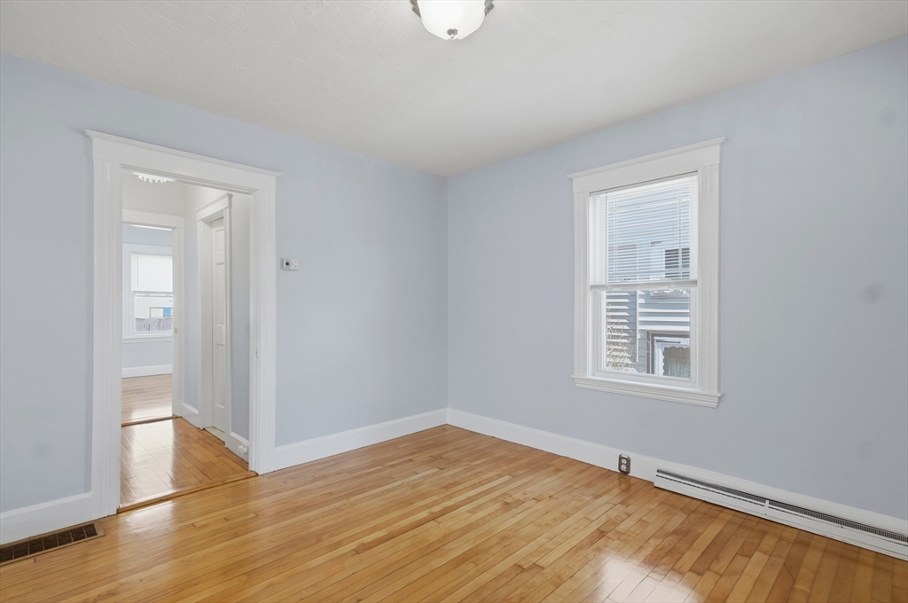 55 Addison Avenue Lynn, MA 01902 - Photo 8 of 23 a view of an empty room with wooden floor and a window