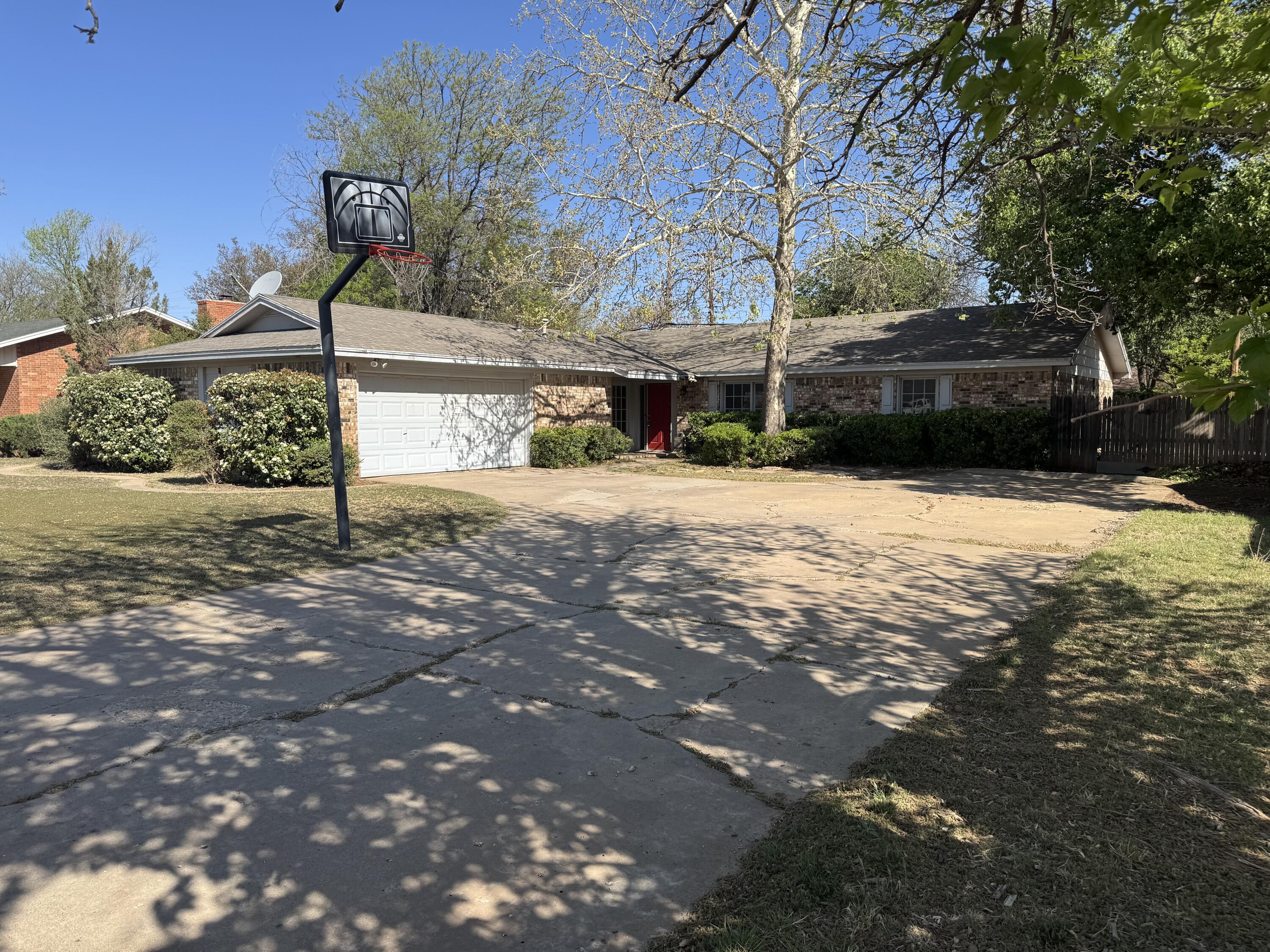 3030 68th Street Lubbock, TX 79413 - Photo 1 of 1 a street view with a bench in front of house