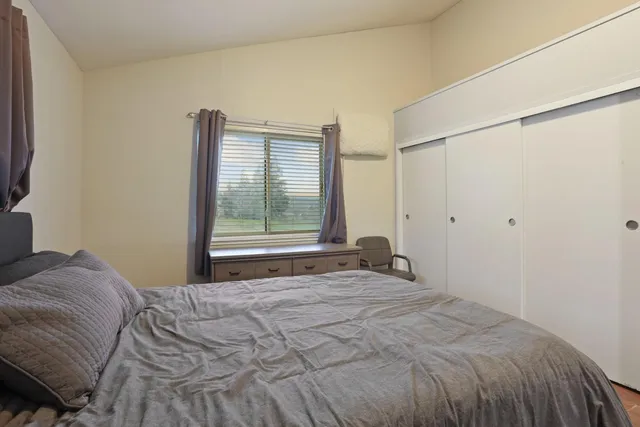 a bedroom with a bed and a window
