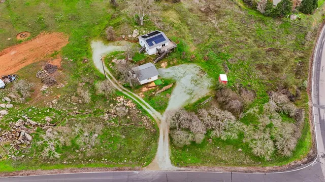 a backyard of a house with yard table and chairs