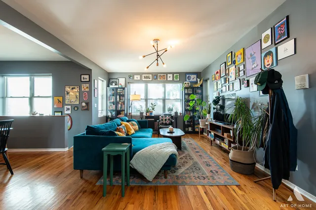 a living room with furniture a window and a flat screen tv