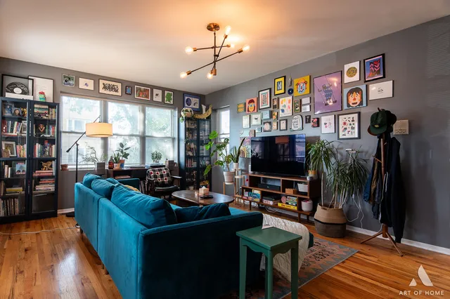 a living room with furniture a flat screen tv and a floor to ceiling window