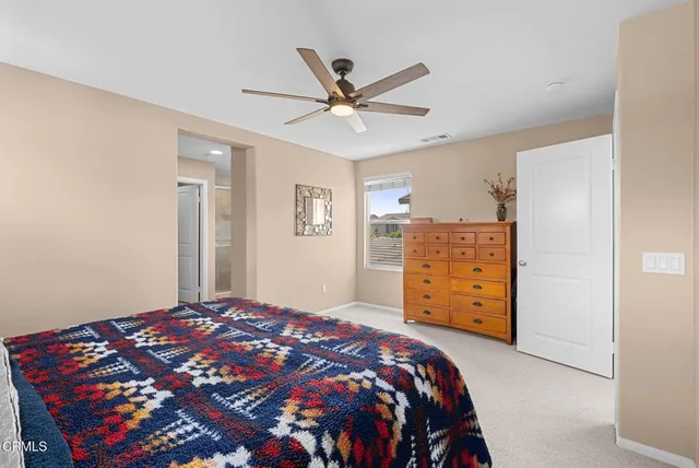 a bedroom with a bed and a dresser