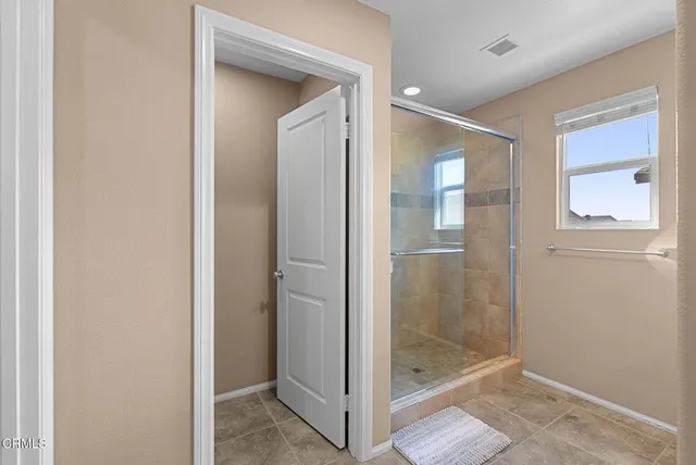 a bathroom with a glass shower door