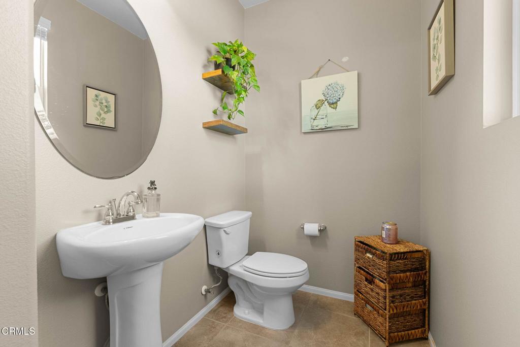 3512 North Oxnard Boulevard Oxnard, CA 93036 - Photo 10 of 41 a bathroom with a toilet a sink and mirror