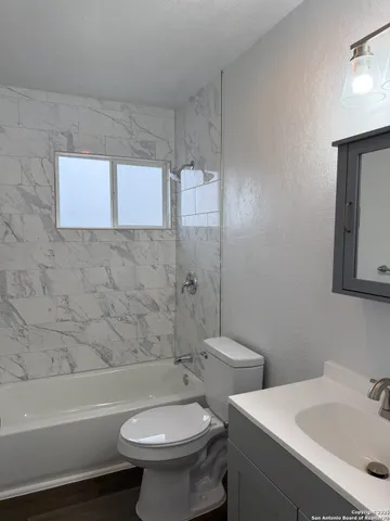 a bathroom with a sink toilet and bathtub
