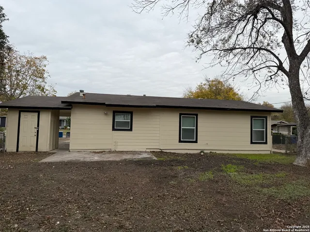 a house that has a tree in front of it