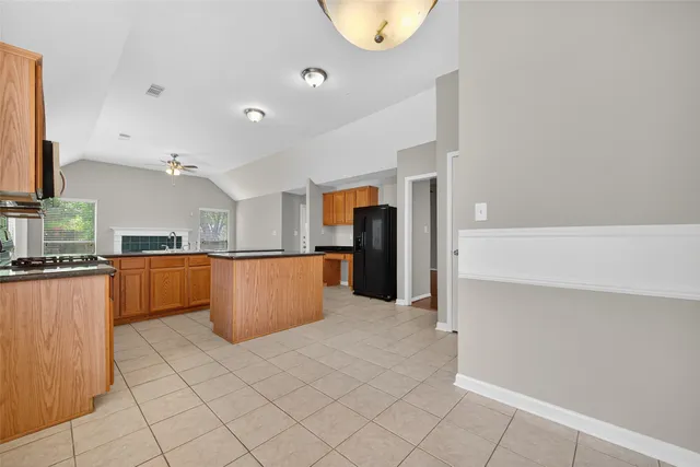 a kitchen with stainless steel appliances a refrigerator and microwave