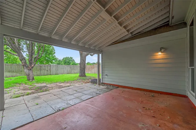 a view of a backyard with large tree