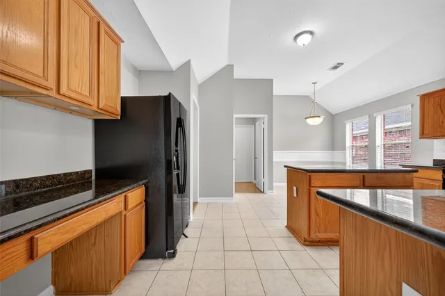 a kitchen with stainless steel appliances a refrigerator and a stove