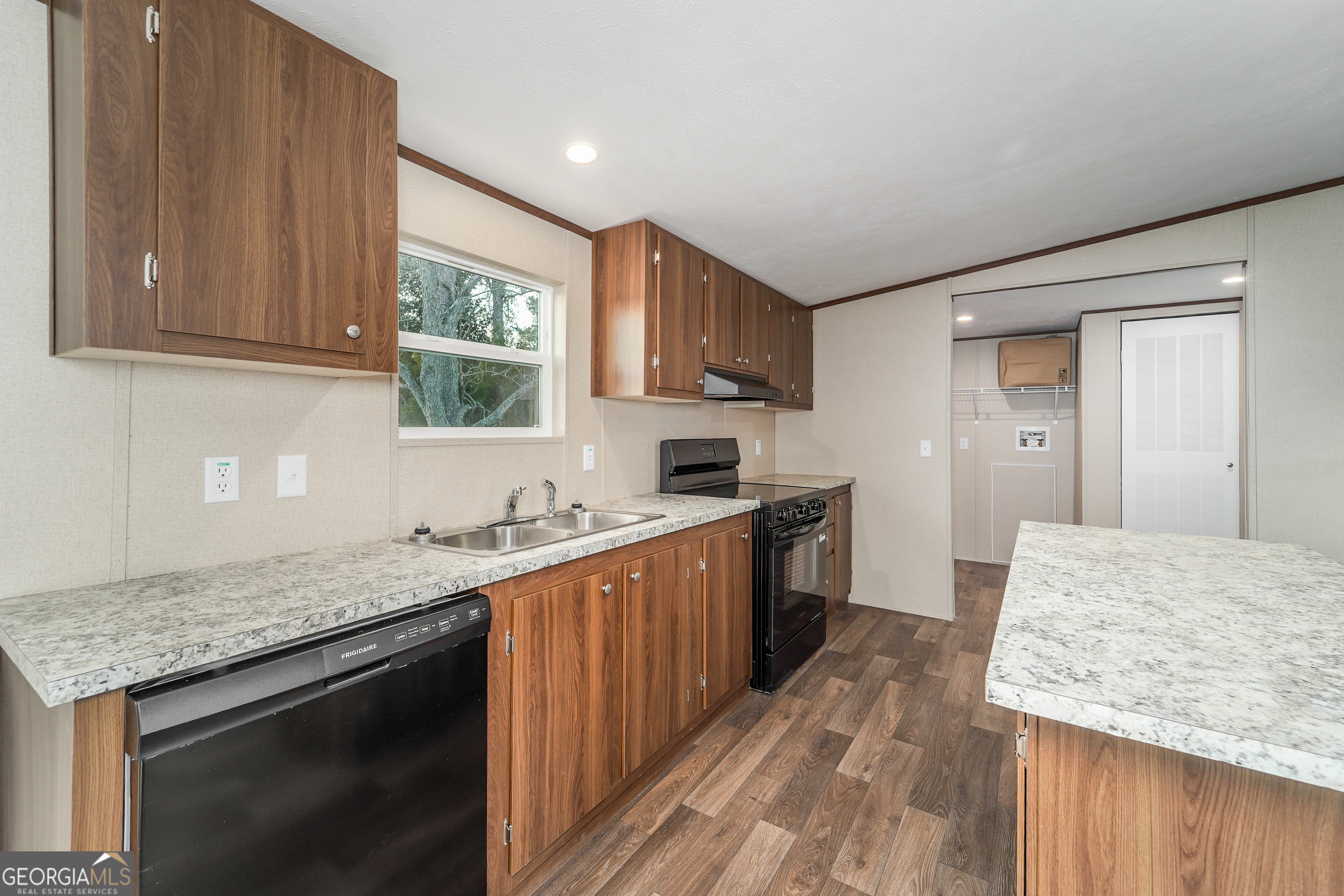1808 Brunel Street Waycross, GA 31503 - Photo 12 of 26 a kitchen with granite countertop cabinets stainless steel appliances a sink and wooden floor