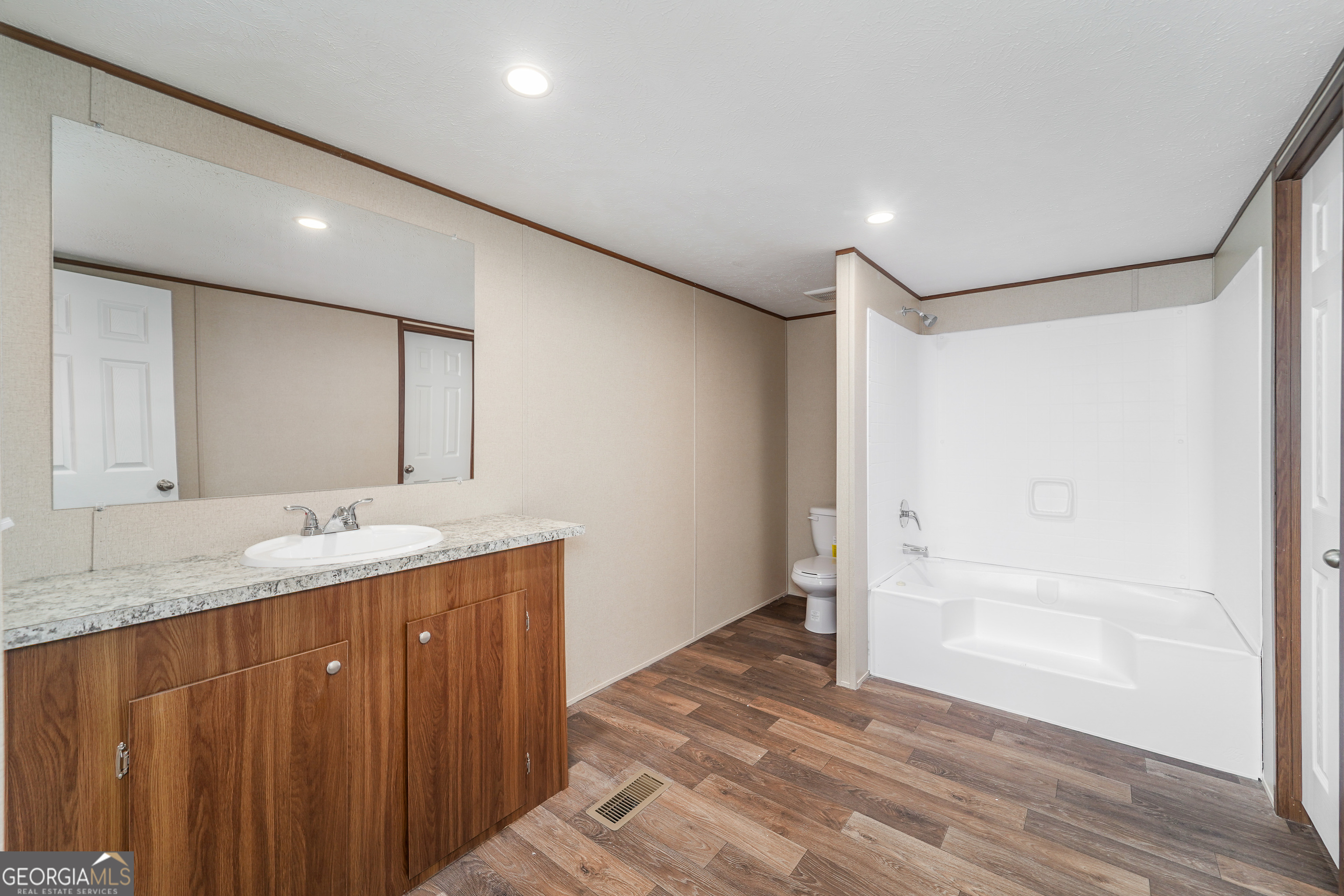 1808 Brunel Street Waycross, GA 31503 - Photo 15 of 26 a bathroom with a granite countertop sink mirror and double