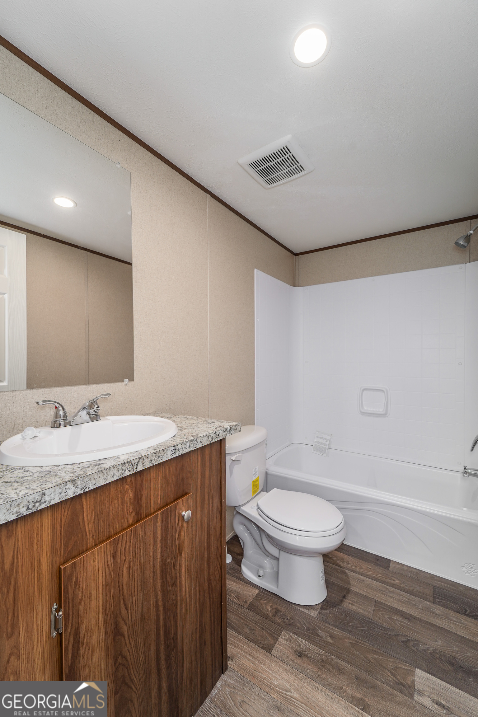 1808 Brunel Street Waycross, GA 31503 - Photo 19 of 26 a bathroom with a granite countertop sink a toilet and a mirror