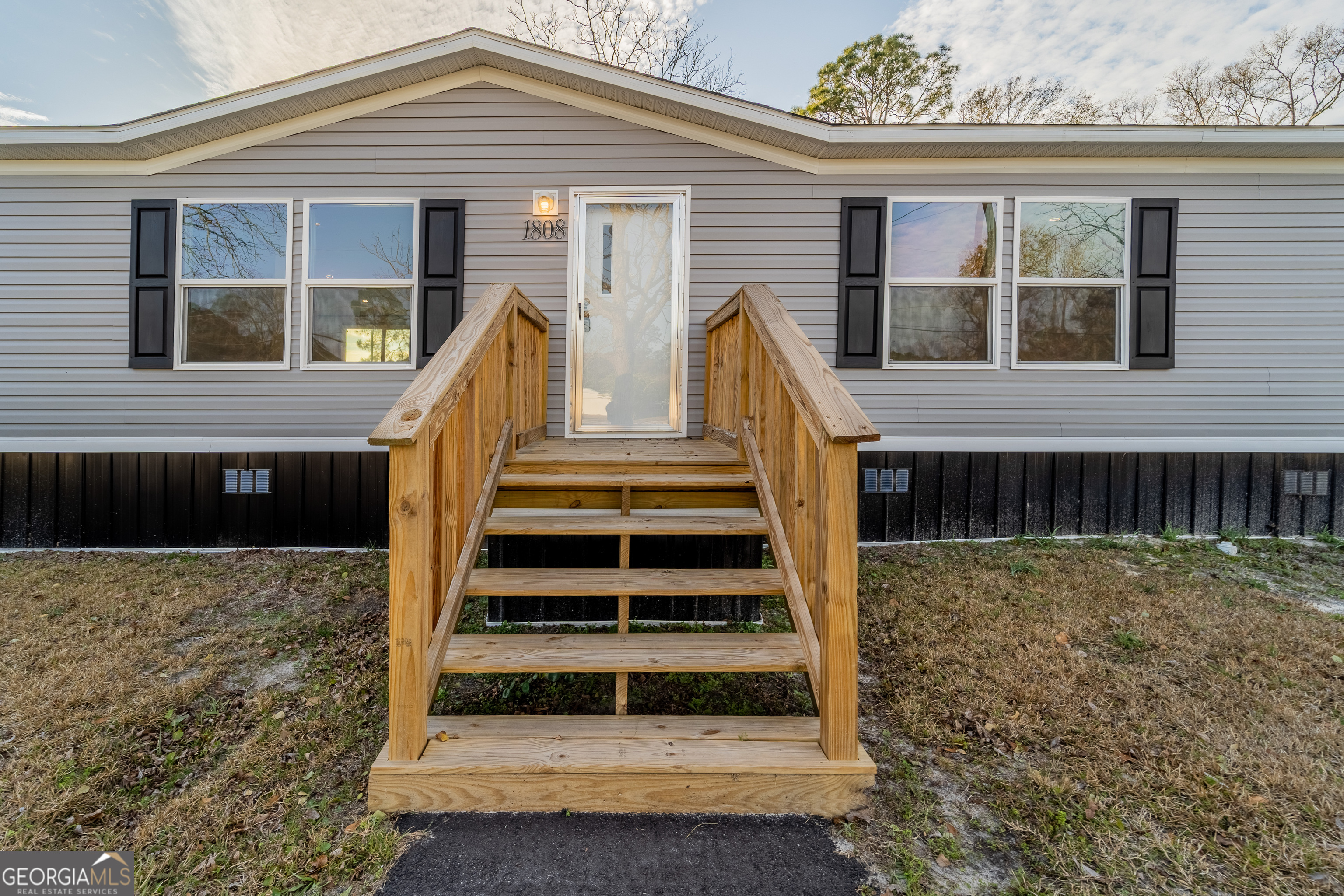 1808 Brunel Street Waycross, GA 31503 - Photo 5 of 26 a view of wooden house with large windows