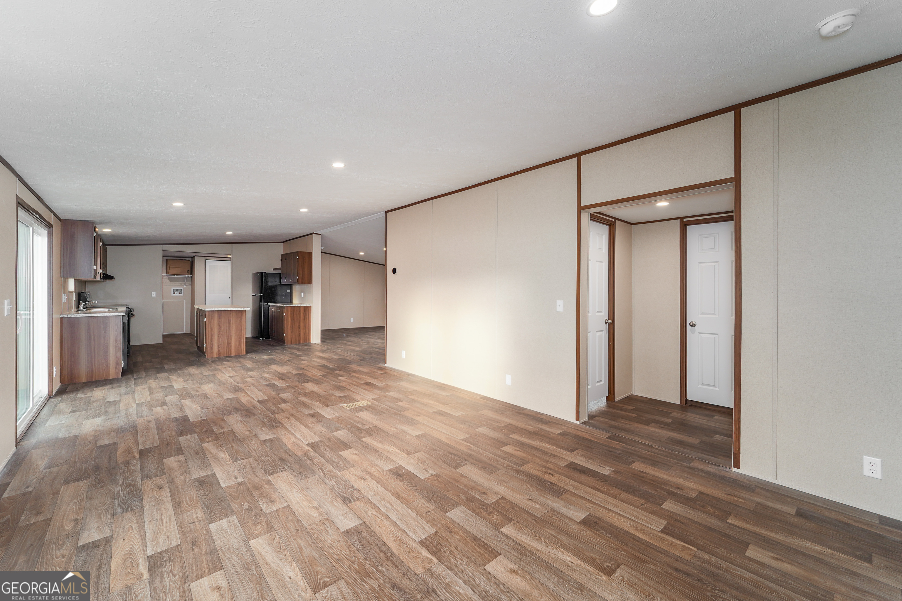1808 Brunel Street Waycross, GA 31503 - Photo 8 of 26 a view of a kitchen with a refrigerator and a cabinets