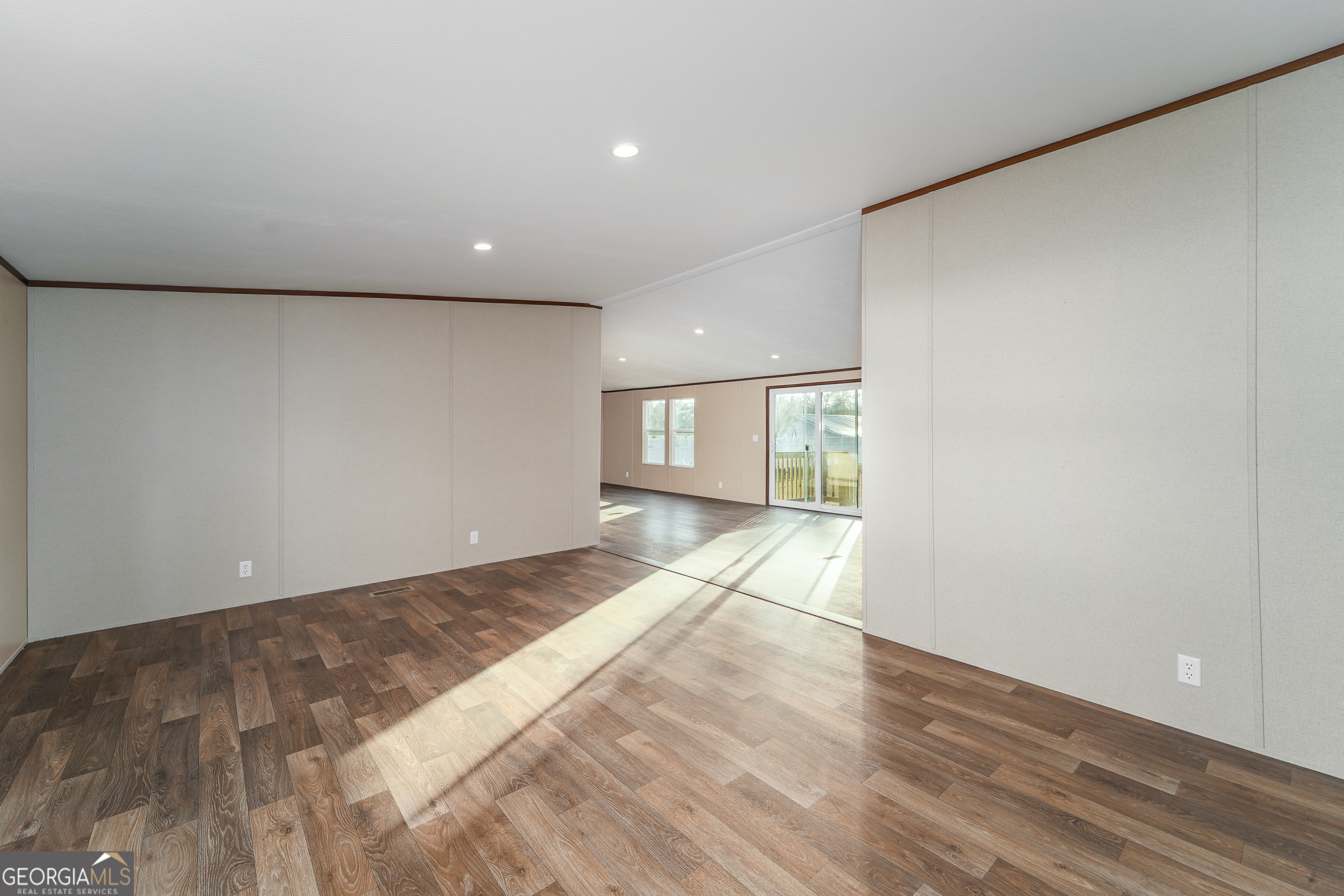 1808 Brunel Street Waycross, GA 31503 - Photo 9 of 26 a view of empty room with wooden floor and fan