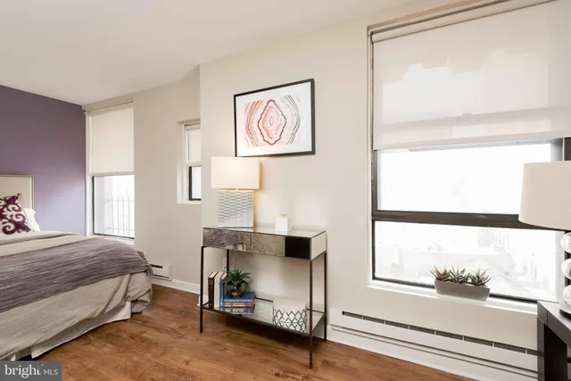 a bedroom with a bed and a window