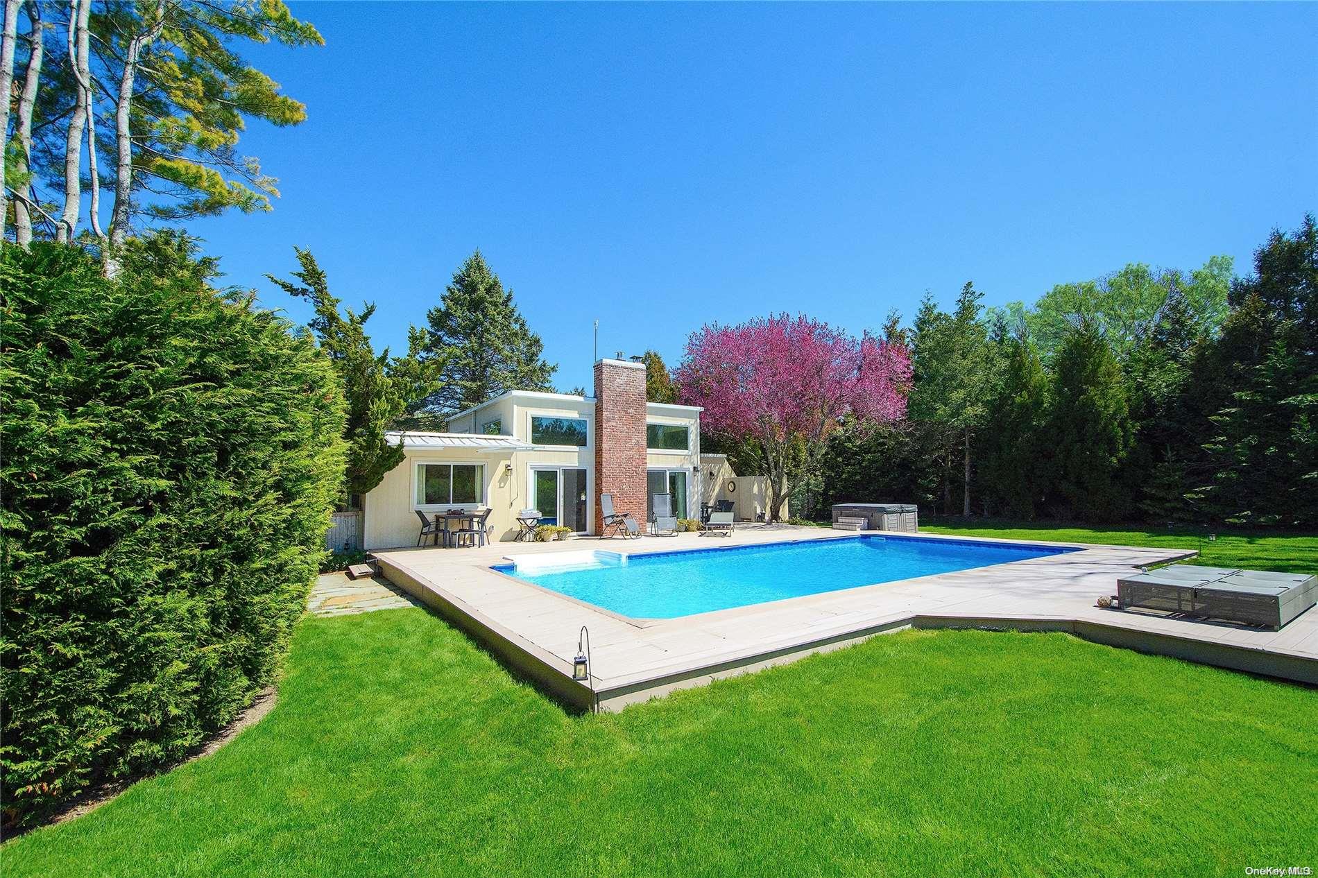a view of a house with pool and yard