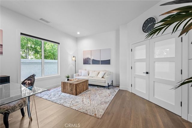 a spacious bedroom with a bed couches and a fireplace