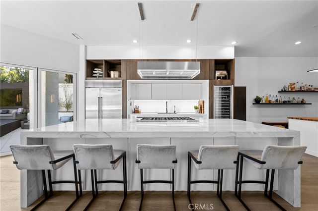 a kitchen with stainless steel appliances granite countertop a sink stove and cabinets