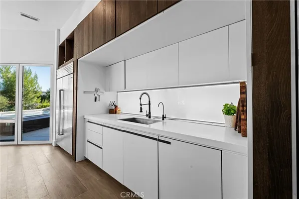 a view of a kitchen with sink washer and dryer
