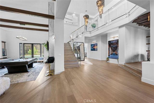 a room with pool table and windows