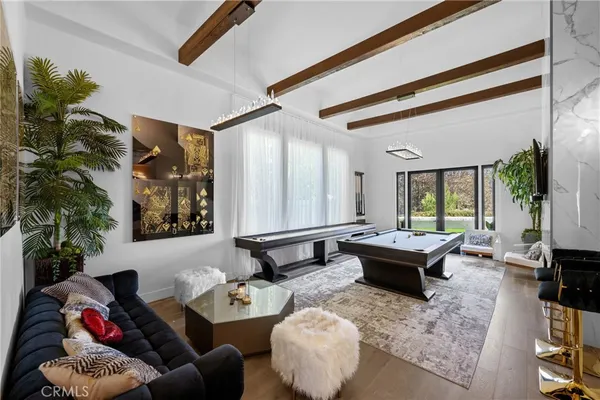 a view of a patio with table and chairs potted plants with wooden floor