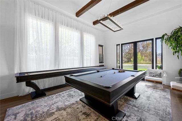 a view of a patio with table and chairs potted plants with wooden floor