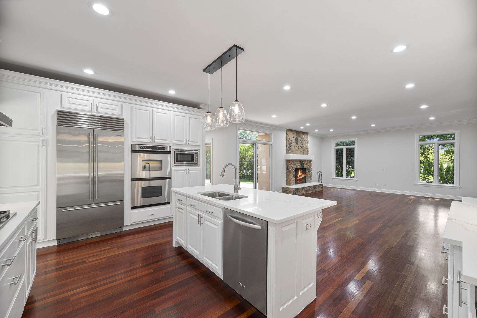 701 Ridge Road Highland Park, IL 60035 - Photo 11 of 60 a large white kitchen with a stove a sink dishwasher and a refrigerator with wooden floor