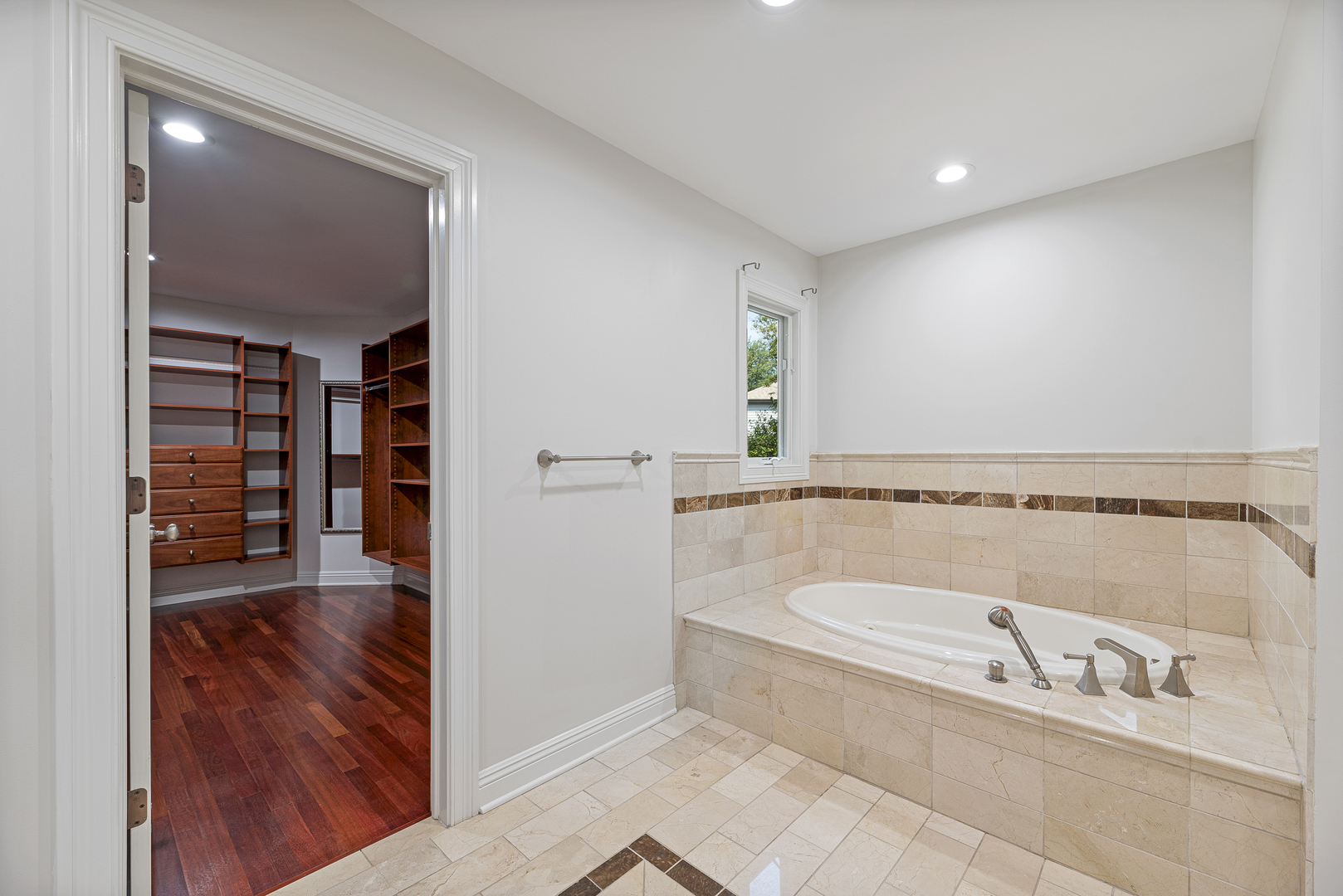 701 Ridge Road Highland Park, IL 60035 - Photo 24 of 60 a bathroom with a tub a rug and a window