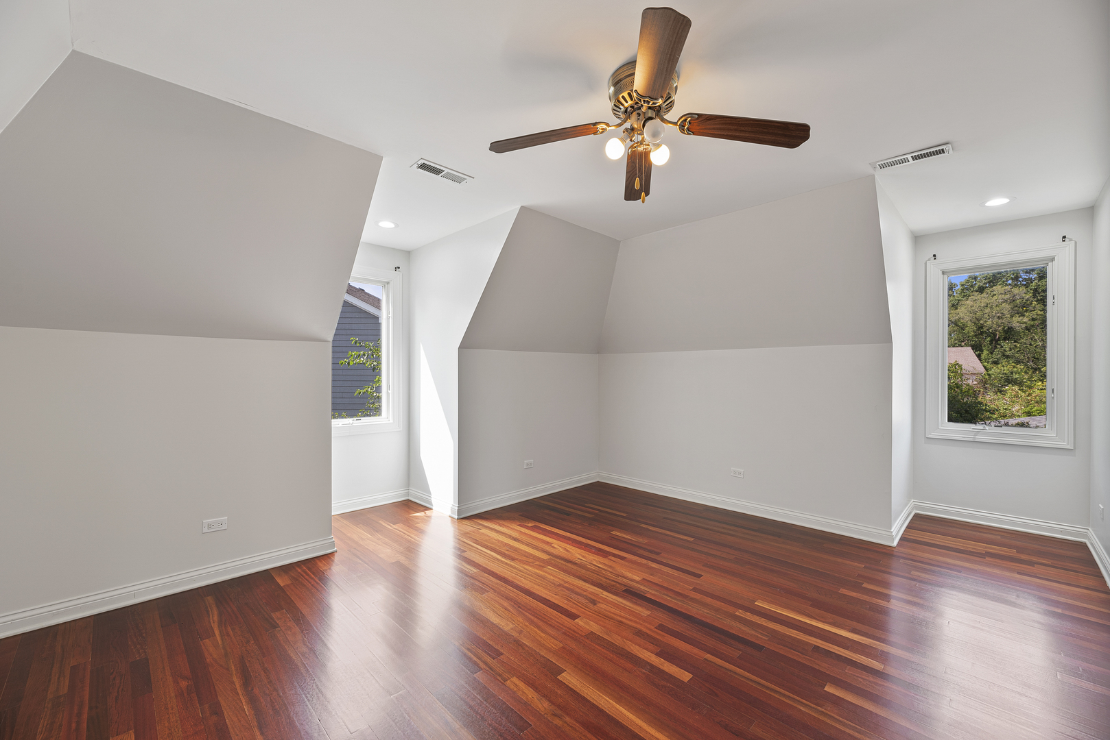 701 Ridge Road Highland Park, IL 60035 - Photo 30 of 60 an empty room with wooden floor chandelier fan and windows