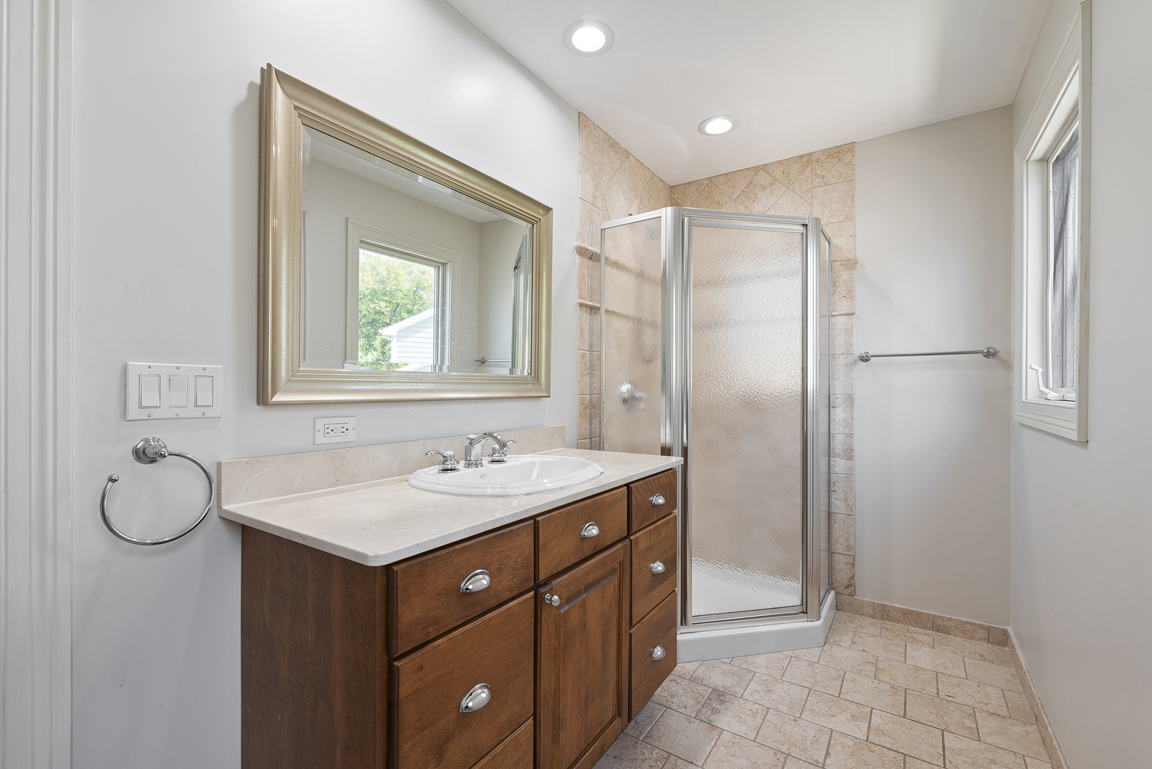701 Ridge Road Highland Park, IL 60035 - Photo 34 of 60 a bathroom with a granite countertop sink mirror and a shower