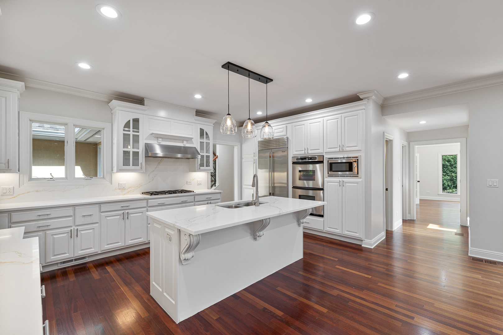 701 Ridge Road Highland Park, IL 60035 - Photo 9 of 60 a large kitchen with stainless steel appliances kitchen island a large counter top and a wooden floors