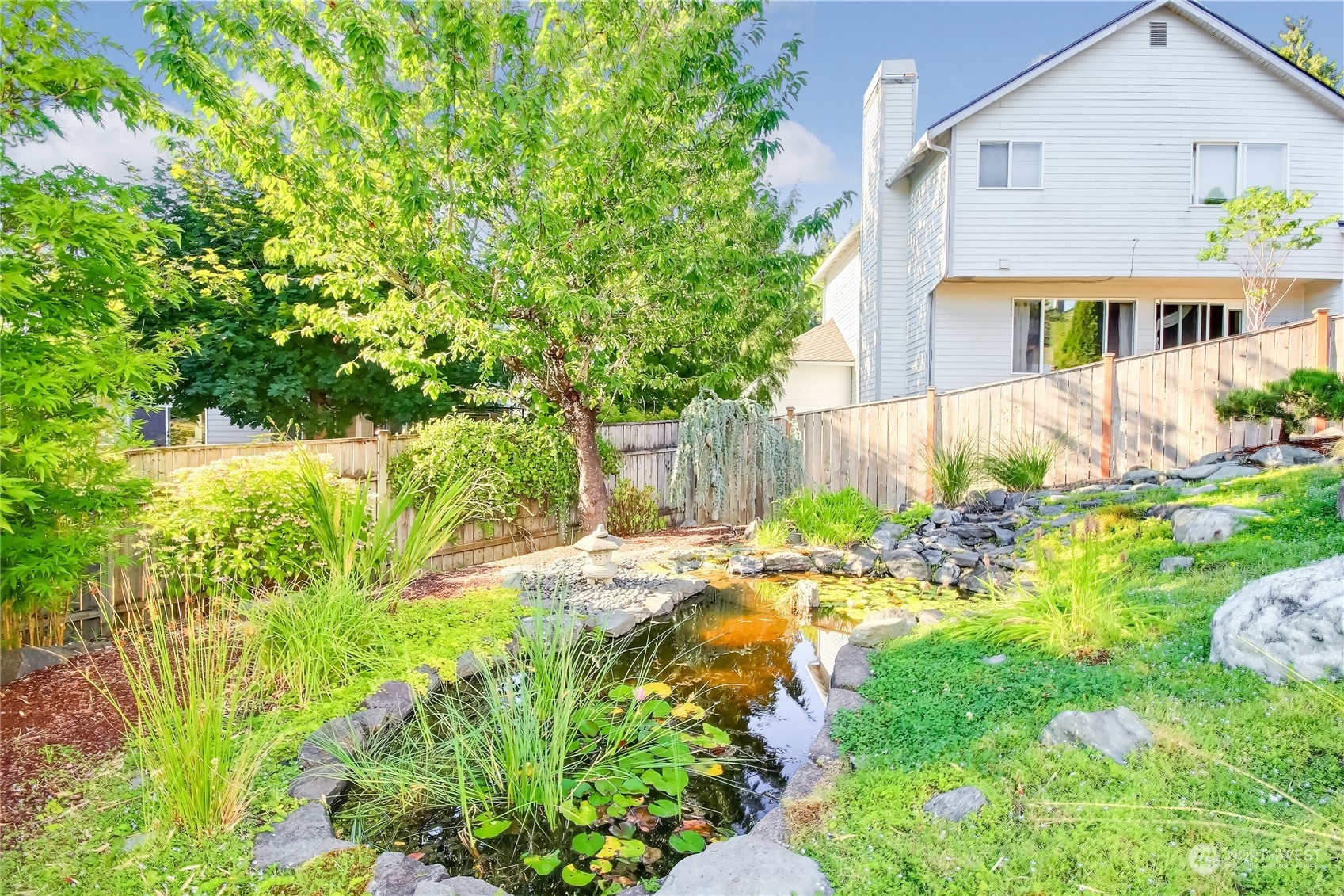 5102 Northeast 17th Street Renton, WA 98059 - Photo 34 of 40 a front view of a house with a yard and a garden