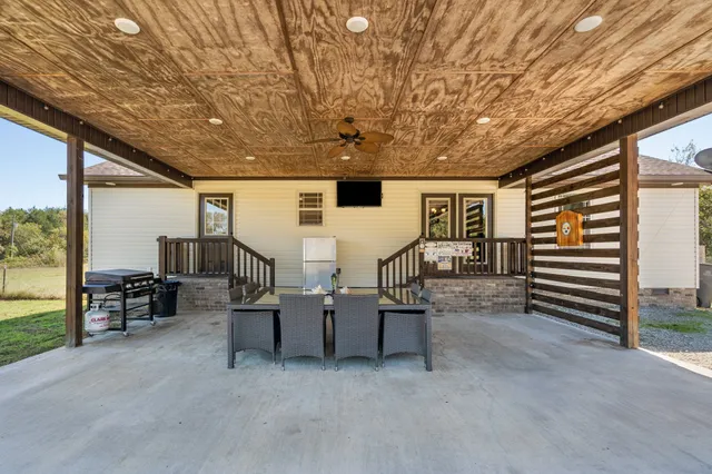 a view of a patio with a table and chairs