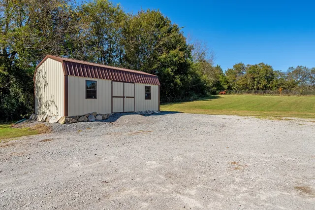a view of a house with pool and chairs