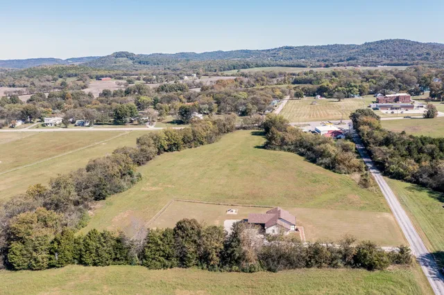 an aerial view of a houses with a lake view