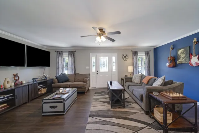 a living room with furniture and a flat screen tv