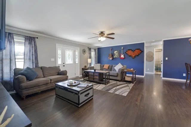 a living room with furniture and wooden floor